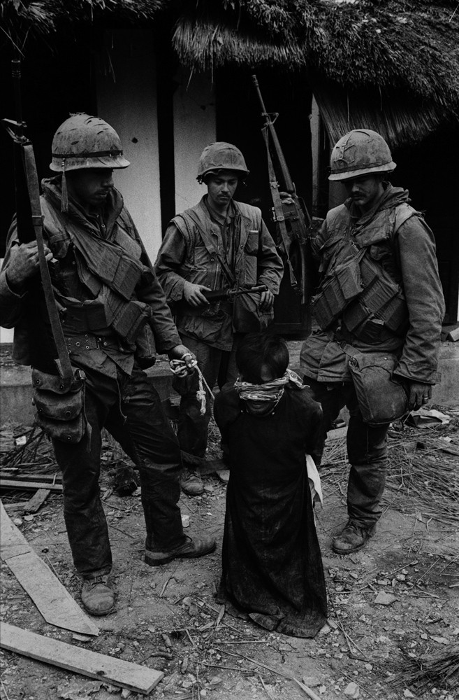 US-Soldiers-tormenting-a-civilian-in-the-old-city-of-Hue-during-the-offensive,-Tet,-Hue,-1968